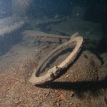 A porthole swings in the current